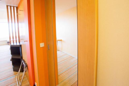 a room with an orange door and a hallway at MAIHAMA VIEW HOTEL by HULIC Formerly Tokyo Bay Maihama Hotel in Urayasu