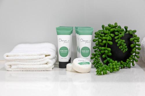 a bathroom with towels and a bunch of green plants at Zen Coastal Hideaway 2BR Modern - Hospital - Beach in Casuarina