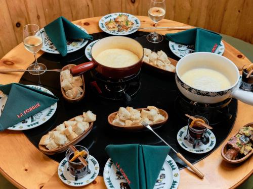 a wooden table with food and glasses of wine at Swissotel Lima in Lima