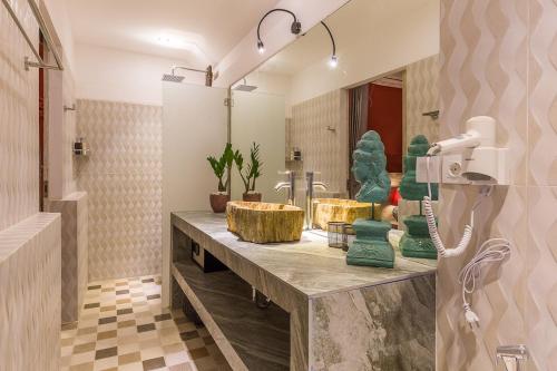 a bathroom with two sinks and a large mirror at Villa Josefine, 5 Bedroom pool, rooftop, pool table in Seminyak