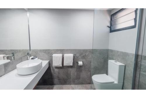 a bathroom with a toilet and a sink and a mirror at Discovery Resorts - Kings Canyon in Kings Canyon