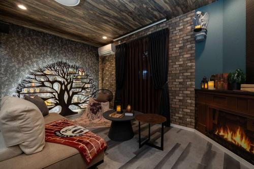a bedroom with a tree mural on the wall at JAPAVISTA Enchant in Osaka