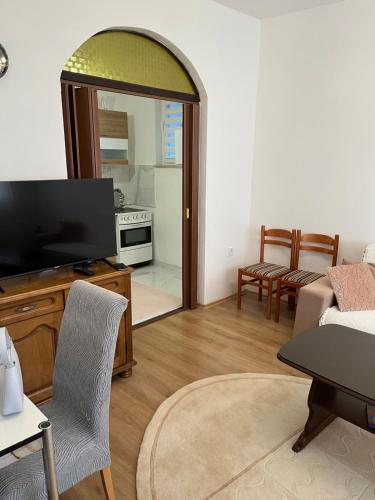 a living room with a flat screen tv and a couch at Old Town Sidro Apartment in Sarajevo