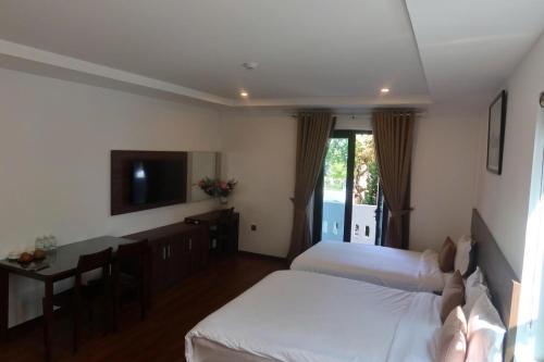 Postel nebo postele na pokoji v ubytování Monoi Suite Nha Trang