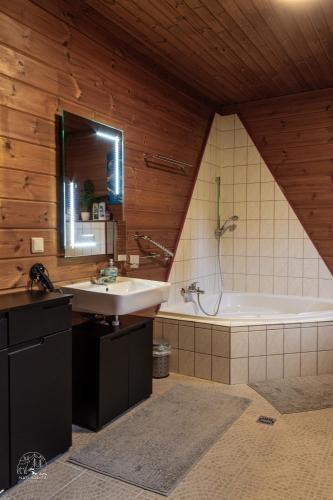a bathroom with a sink and a bath tub at Holzblockhaus, Eifel in Oberkail
