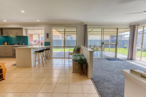 an open kitchen and living room with sliding glass doors at Marine Holiday Home - Geographe in Geographe