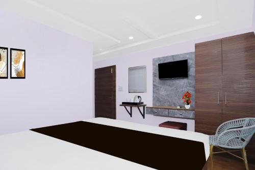 a bedroom with a large bed and a chair at Super Townhouse Rauniyar City Centre Ratu Road in Rānchī