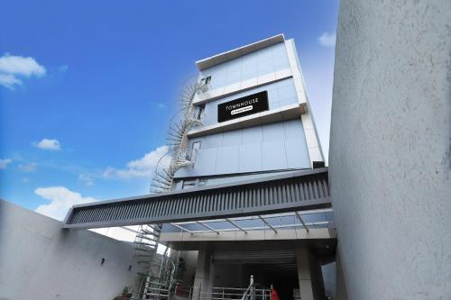 a building with a sign on the side of it at Super Townhouse Rauniyar City Centre Ratu Road in Rānchī