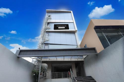 a building with a sign on the side of it at Super Townhouse Rauniyar City Centre Ratu Road in Rānchī