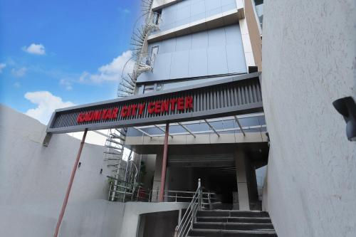 a building with a sign on the side of it at Super Townhouse Rauniyar City Centre Ratu Road in Rānchī