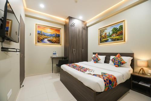 a hotel room with a bed and a television at Via Alpha in Gurgaon