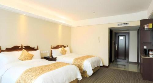 a hotel room with two beds in a room at Yanji Yanbian International Hotel in Yanji