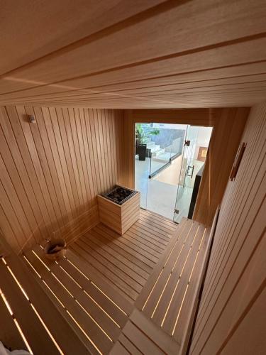 a sauna with a wooden floor and a window at Hotel Prishtina in Pristina