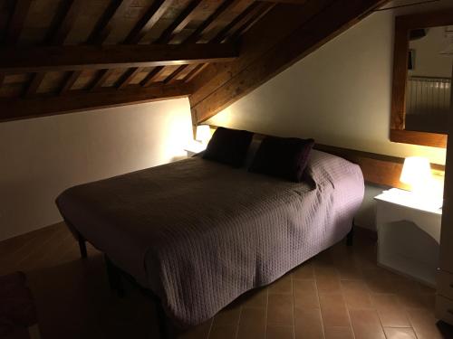 a bedroom with a bed with two pillows on it at Guest House Dimora Fiorita in Serracapriola