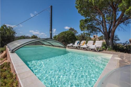 una piscina con tumbonas y una piscina en Villa La Licciola, en Cala Bitta