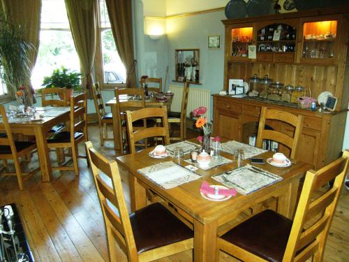 a dining room with a wooden table and chairs at Bridge House Bed & Breakfast in Newark-on-Trent