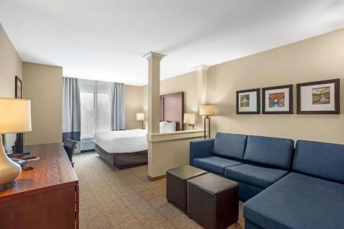 a hotel room with a couch and a bed at Comfort Inn & Suites Gap Amish Country in Gap
