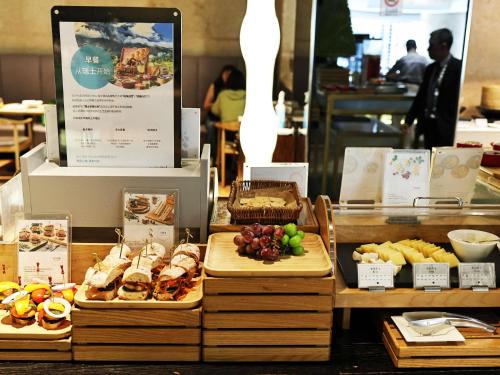 a buffet with different types of food on display at Swissôtel Grand Shanghai - Stroll down West Nanjing Road and soak in downtown Shanghai vibrancy in Shanghai