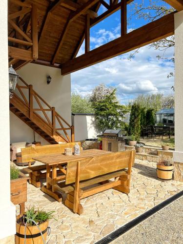 a wooden bench sitting on a stone patio at Deer Apartment in Lipí