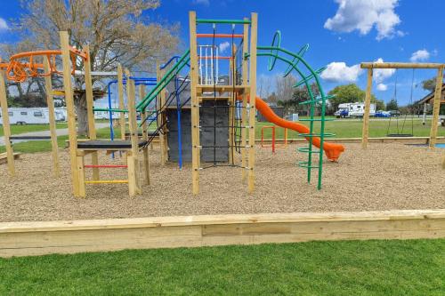 a playground with a slide in a park at Havelock North Holiday Park in Havelock North
