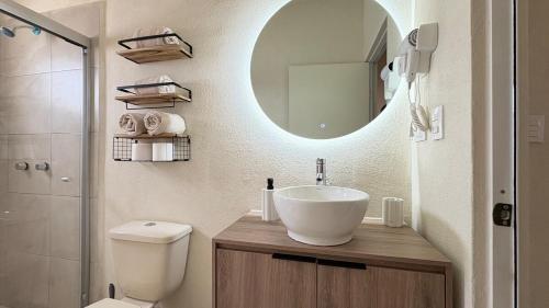a bathroom with a sink and a toilet and a mirror at Casa Bárbara Totalmente Nueva in Hermosillo