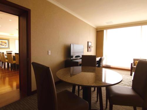 a dining room with a table and chairs at Swissotel Quito in Quito