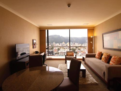 a living room with a couch and a table at Swissotel Quito in Quito