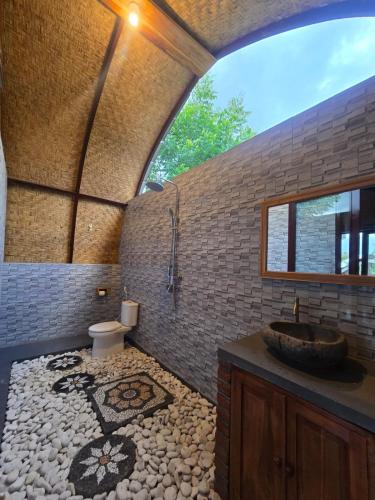 a bathroom with a sink and a toilet at Eco Moringa Garden in Banyuwedang