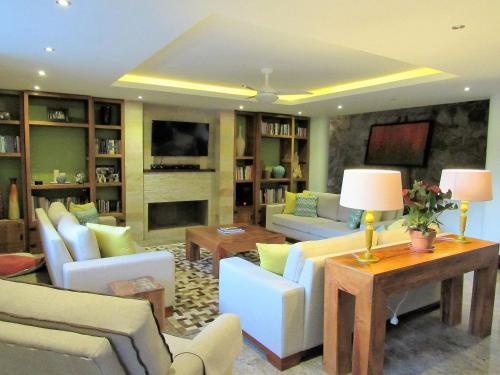 a large living room with couches and a tv at Casa Verde Río in Rio de Janeiro