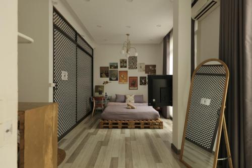 a bedroom with a bed and a large mirror at Langmandi Experience Nhà Thờ in Hanoi