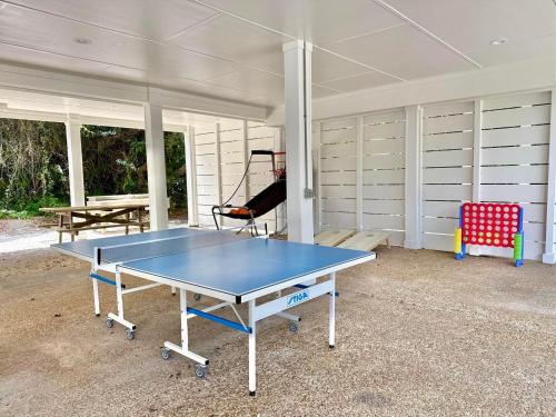 a ping pong table sitting inside of a garage at About Time-Private Pool-Newly Remodeled in St. George Island