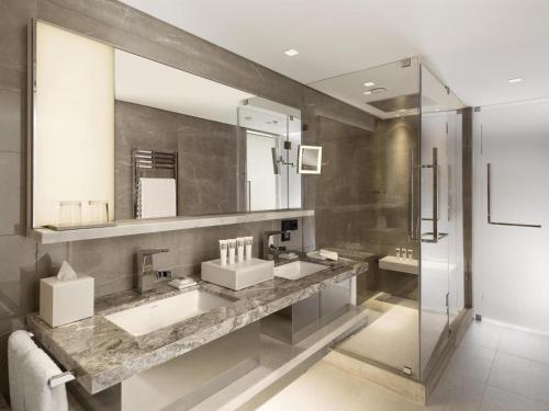 a bathroom with two sinks and a large mirror at Swissotel The Bosphorus Istanbul in Istanbul