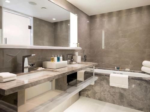 a bathroom with a sink and a bath tub at Swissotel The Bosphorus Istanbul in Istanbul