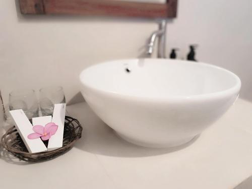 a white sink and a bowl on a counter at Oasi Bungalow Gili Air in Gili Islands