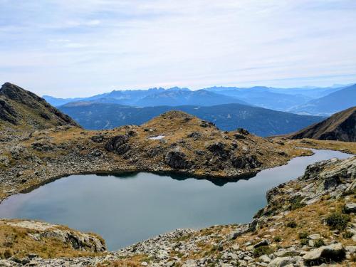 a tarn on the side of a mountain at Residence Aichner in Brunico