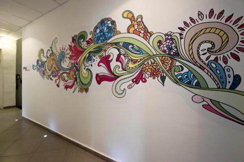 a wall with a colorful mural on a wall at 1926 Designed ApartHotel in Haifa