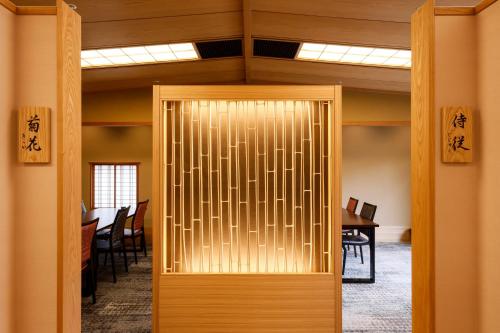 an entrance to an office with a wooden door at Ginsuisou Choraku in Kobe