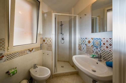 a bathroom with a sink and a toilet and a shower at Affittacamere Amunì in Castellammare del Golfo