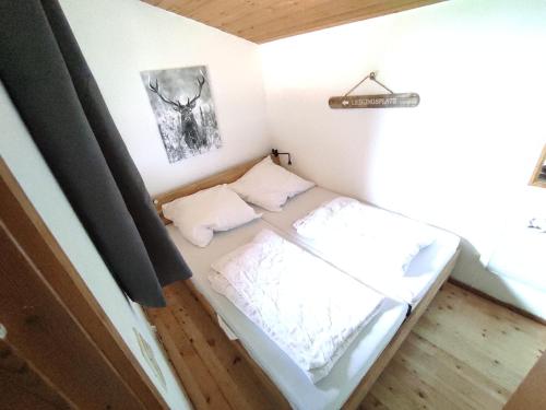 a small bed in a room with a window at Wald Chalet Nr 2 in Kellenhusen
