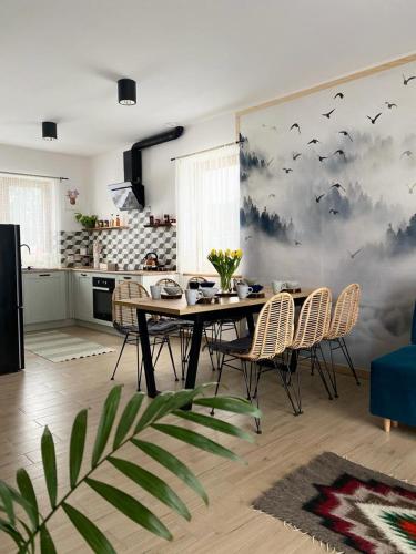 a dining room with a table and chairs in a kitchen at Wilczy Domek Cisna in Cisna