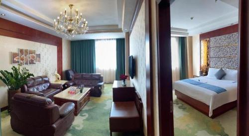 a hotel room with a bed and a living room at Shenzhen Kai Long International Hotel in Shenzhen