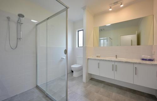 a bathroom with a glass shower and a toilet at Comfort Inn & Suites Augusta Westside in Port Augusta