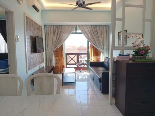a living room with a ceiling fan and a dining room at One Bedroom NO Heater ,Mahkota Hospital , Parade , Pahlawan in Melaka