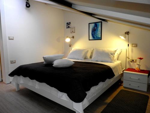 a bedroom with a large bed with two pillows at Delight Loft in Rovinj