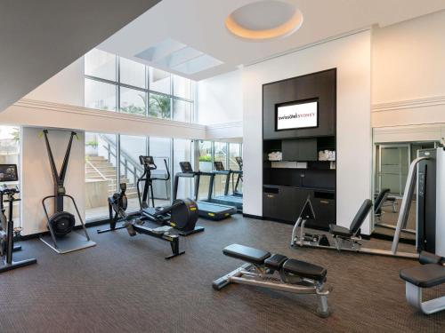 a gym with treadmills and cardio equipment in a building at Swissotel Sydney in Sydney