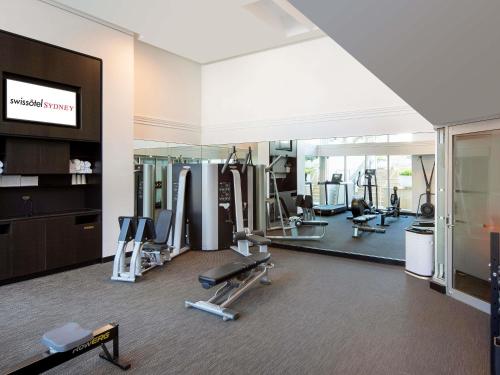 a gym with treadmills and machines in a building at Swissotel Sydney in Sydney