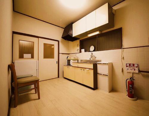 a kitchen with a sink and a counter at Osaka KAYA Traditional Tatami house 2-6 ppl near station and park direct to KIX airport in Osaka