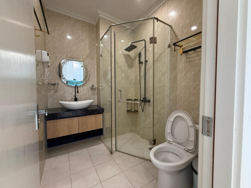 a bathroom with a toilet and a sink and a shower at Three women in Phu Quoc