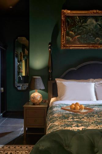 a bedroom with a bed with a plate of oranges on it at G'Villa Thảo Điền in Ho Chi Minh City