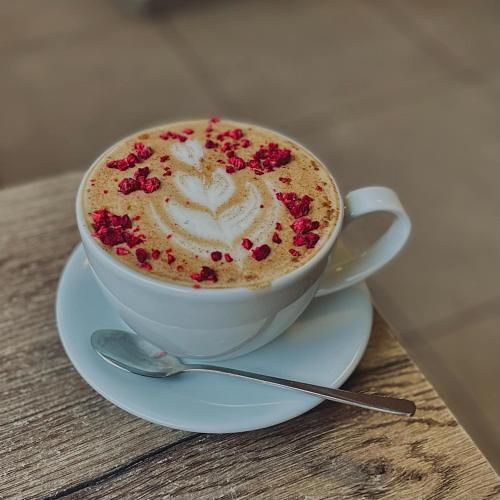 a cup of coffee on a plate on a table at Demaris in Třebíč
